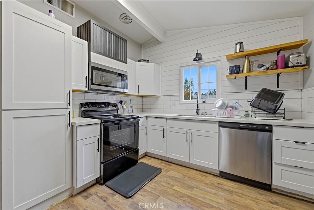 2690 Hawthorne Avenue Merced, CA 95340 - Photo 17 of 36 a kitchen with stainless steel appliances granite countertop a stove a sink and a microwave