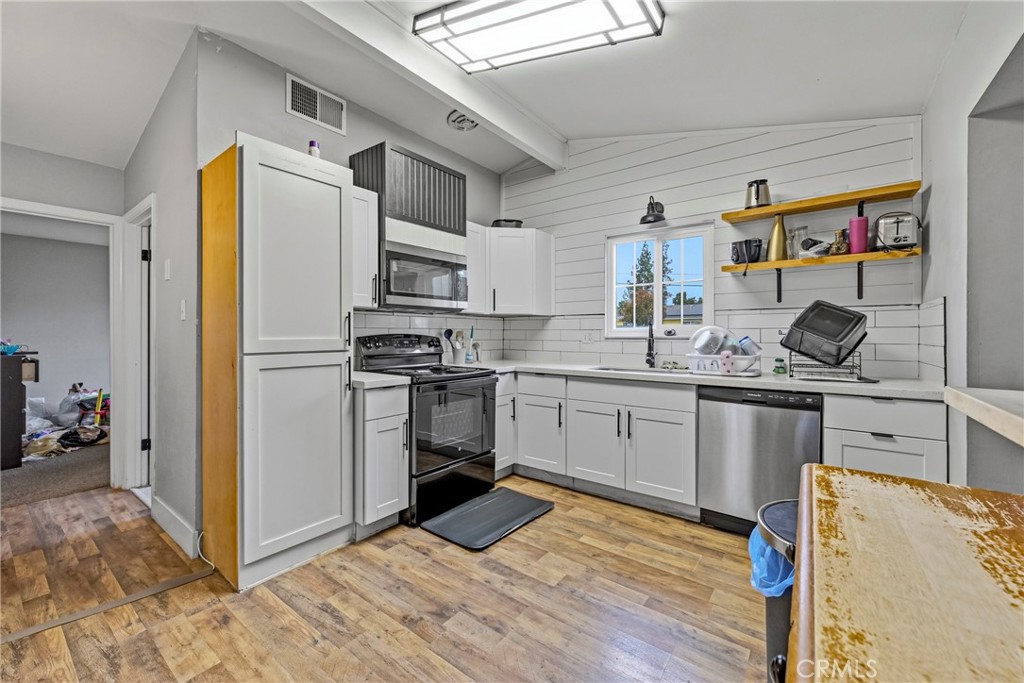 2690 Hawthorne Avenue Merced, CA 95340 - Photo 18 of 36 a kitchen with stainless steel appliances granite countertop a sink stove and refrigerator
