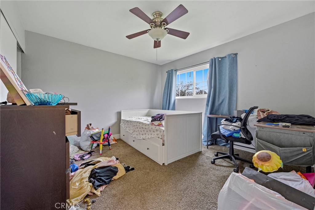 2690 Hawthorne Avenue Merced, CA 95340 - Photo 26 of 36 a bedroom with bed and a chandelier