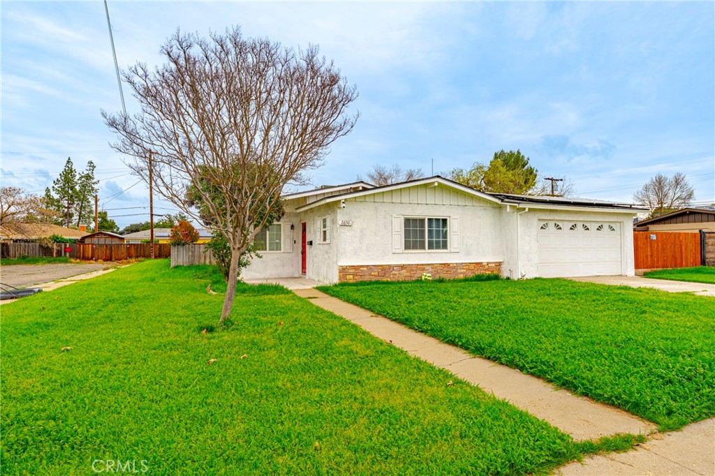 2690 Hawthorne Avenue Merced, CA 95340 - Photo 8 of 36 a view of a white house with a big yard plants and large trees