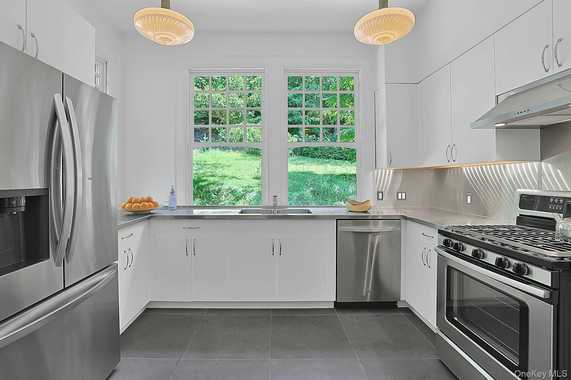 20 Nazareth Way Cold Spring, NY 10516 - Photo 14 of 50 Four beautiful, matching glass fixtures cast warm light down. There is also convenient under-cabinet lighting here. There is ample cabinet space and the five burner stove can handle any recipe. Underfoot, the ceramic tile floor is easy to clean.