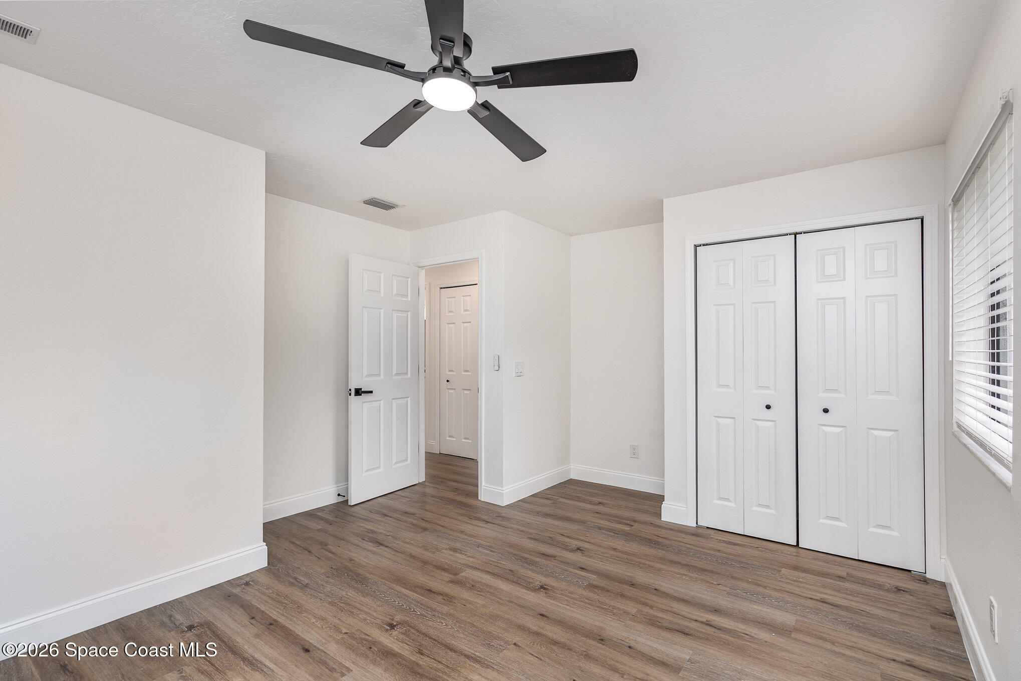 362 Nikomas Way Melbourne Beach, FL 32951 - Photo 18 of 32 an empty room with wooden floor a ceiling fan and closet