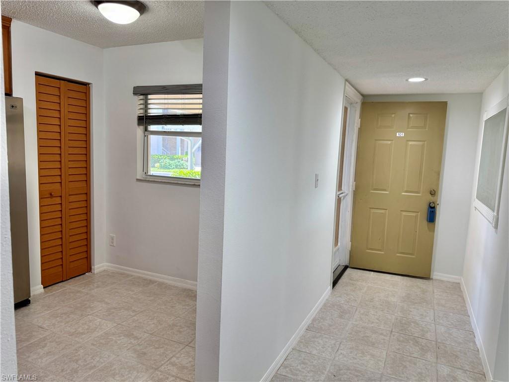 661 Squire Circle, Unit 101 Naples, FL 34104 - Photo 20 of 25 a view of hallway with natural light