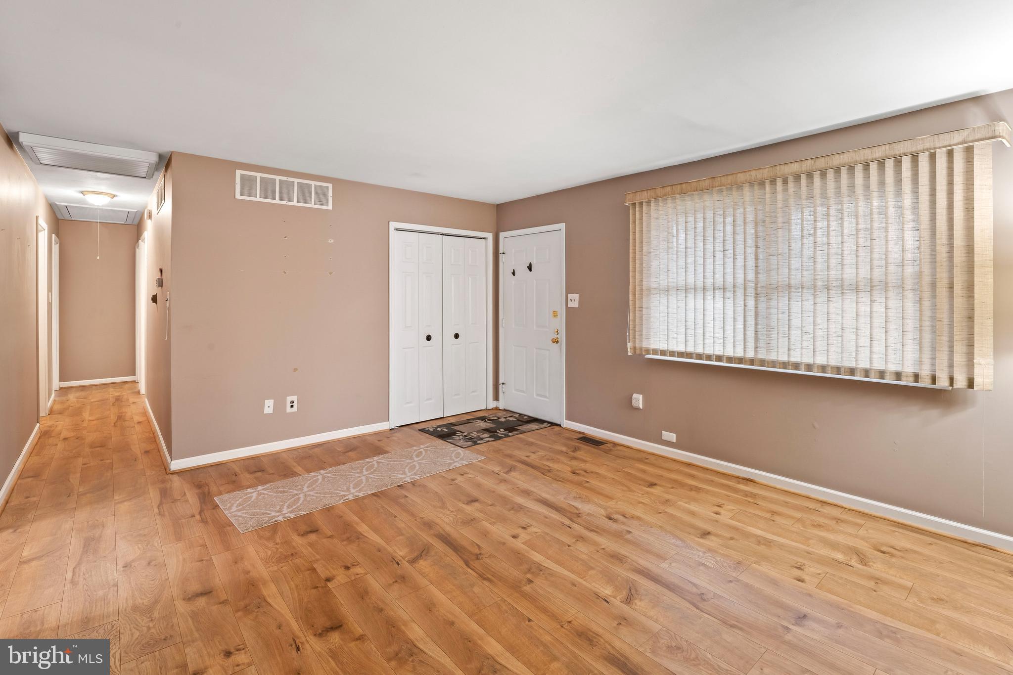 117 East 12th Avenue Pine Hill, NJ 08021 - Photo 5 of 19 a view of an empty room with wooden floor and a window