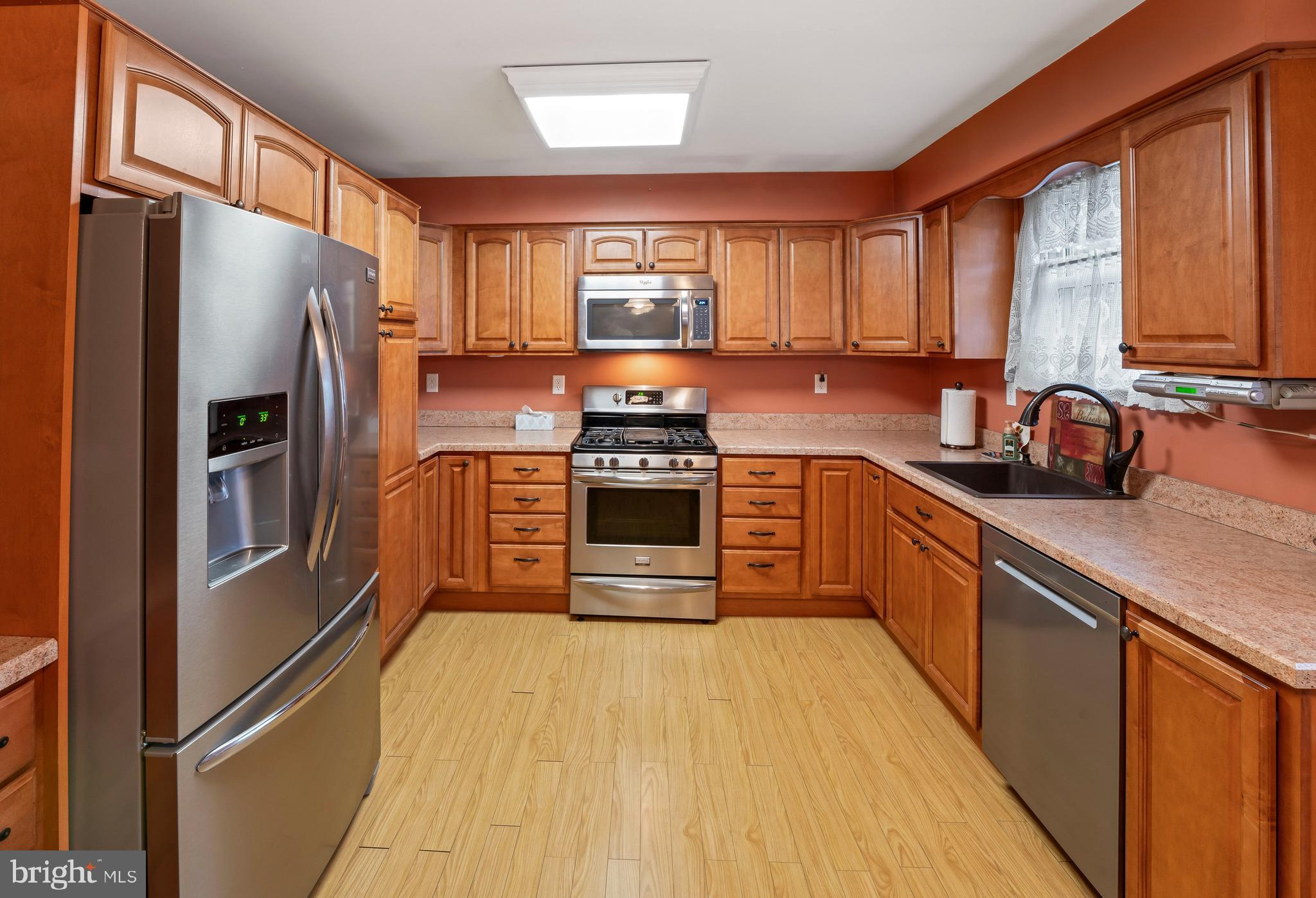 117 East 12th Avenue Pine Hill, NJ 08021 - Photo 7 of 19 a kitchen with stainless steel appliances a stove sink and refrigerator