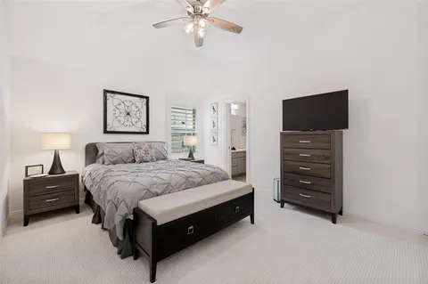 a spacious bedroom with a bed and a dresser