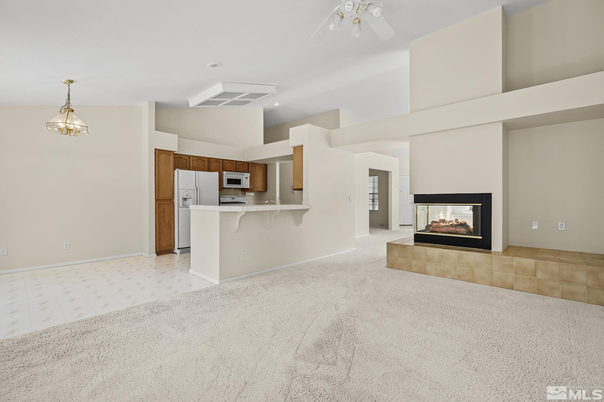 5875 Simons Drive Reno, NV 89523 - Photo 12 of 26 an empty room with windows and fireplace