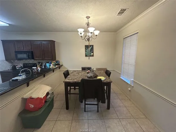 a very nice looking dining room with a table and chairs