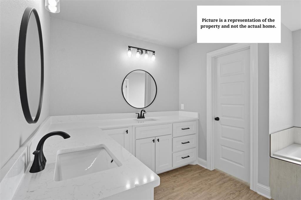 7635 Hudson Way Abilene, TX 79602 - Photo 11 of 17 a bathroom with a sink and a mirror