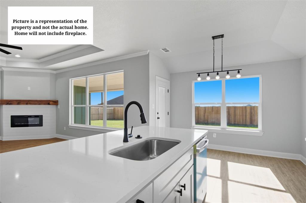 7635 Hudson Way Abilene, TX 79602 - Photo 5 of 17 a kitchen with a sink a stove and a microwave