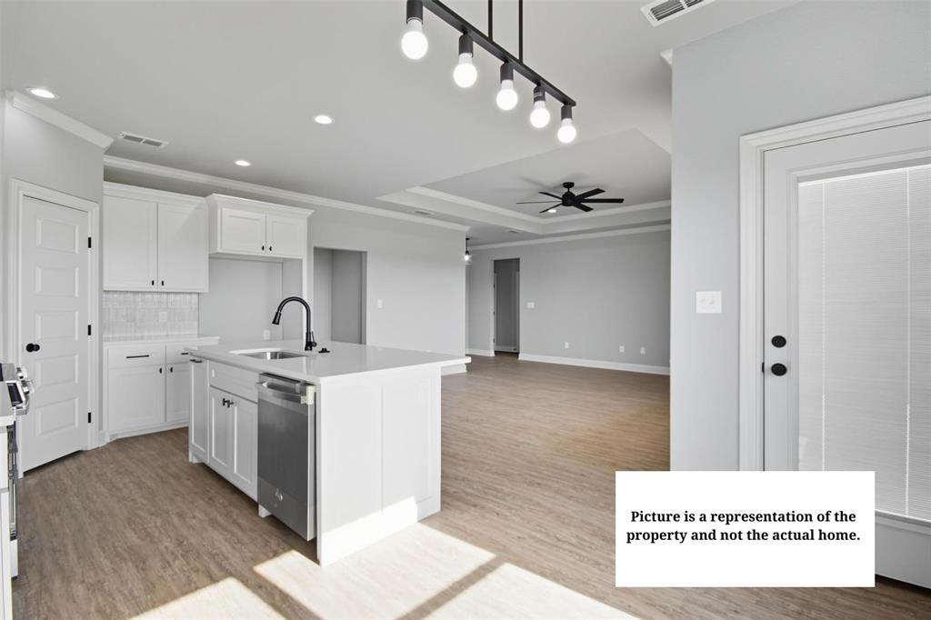 7635 Hudson Way Abilene, TX 79602 - Photo 6 of 17 a kitchen with stainless steel appliances kitchen island a stove a sink and a refrigerator with wooden floor