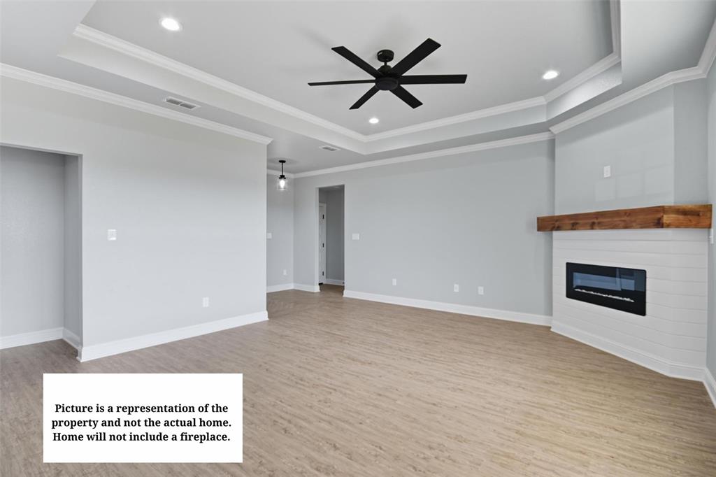 7635 Hudson Way Abilene, TX 79602 - Photo 7 of 17 a view of a big room with wooden floor and a ceiling fan