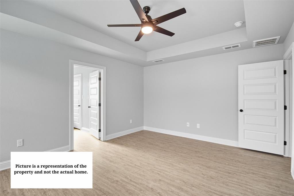 7635 Hudson Way Abilene, TX 79602 - Photo 9 of 17 a view of a room with wooden floor and a ceiling fan