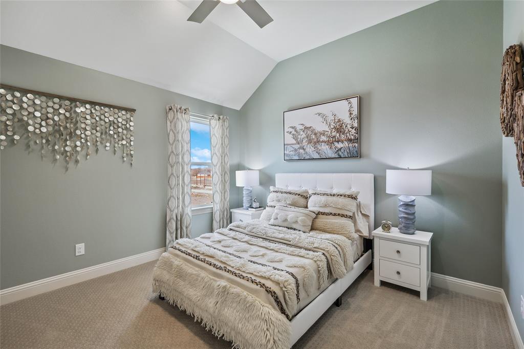 1604 Casting Ridge Mesquite, TX 75181 - Photo 29 of 38 Carpeted room featuring a vaulted ceiling with a ceiling fan, a window with curtains, and two-drawer nightstands