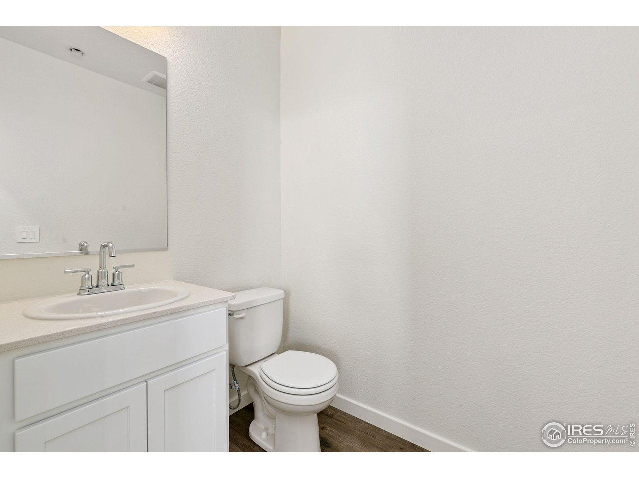 417 Condor Way Johnstown, CO 80534 - Photo 4 of 11 a bathroom with a toilet a sink and mirror