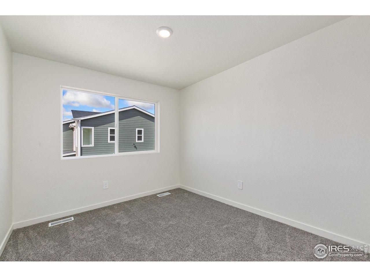 417 Condor Way Johnstown, CO 80534 - Photo 7 of 11 a view of an empty room with a window