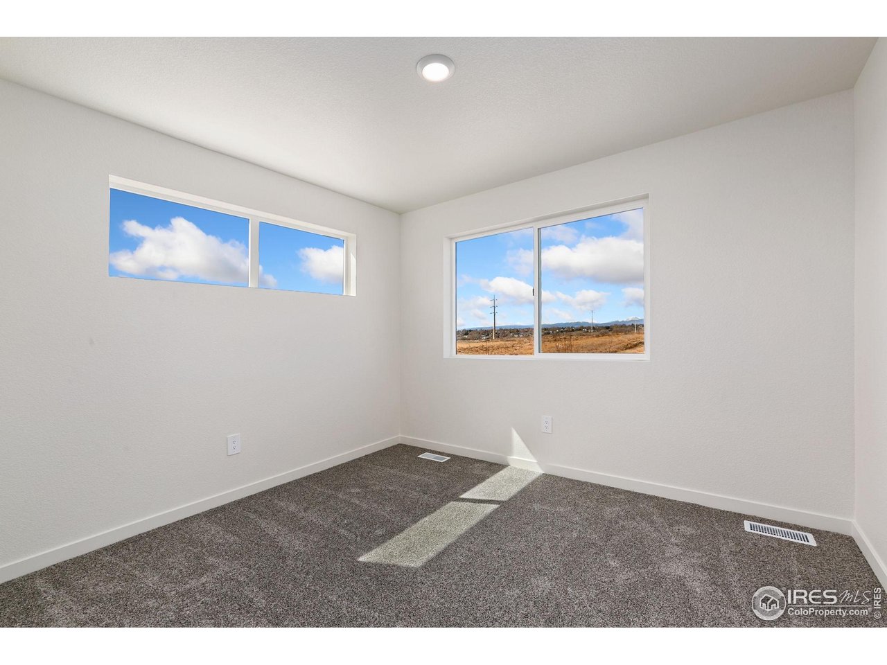 417 Condor Way Johnstown, CO 80534 - Photo 8 of 11 an empty room with windows