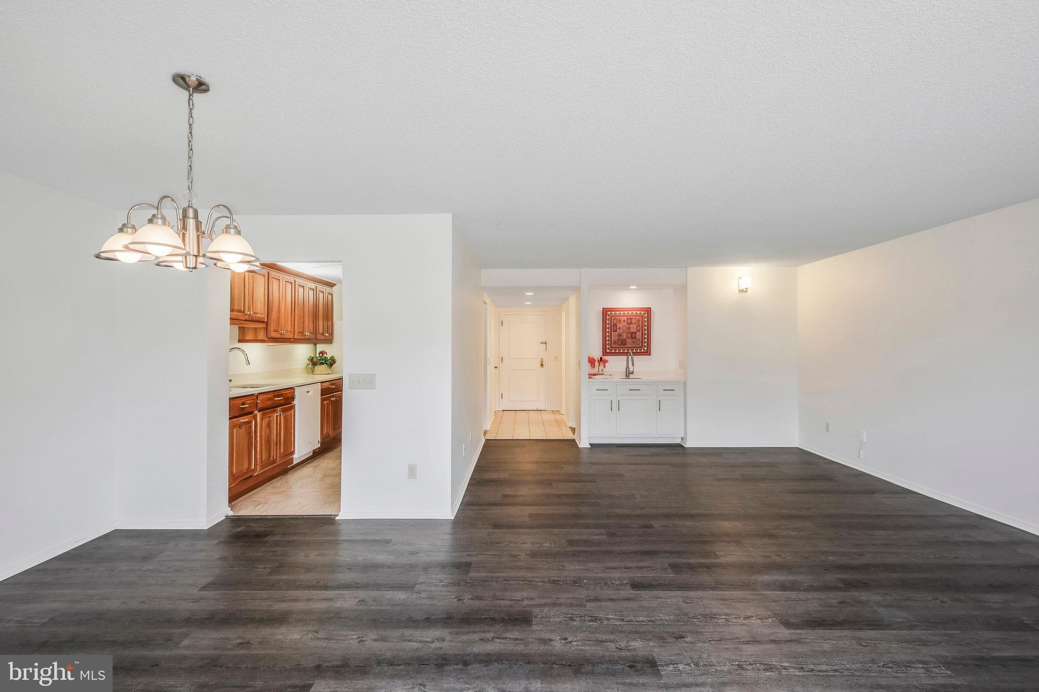 6101 Edsall Road, Unit 712 Alexandria, VA 22304 - Photo 8 of 53 a view of an empty room with window and wooden floor