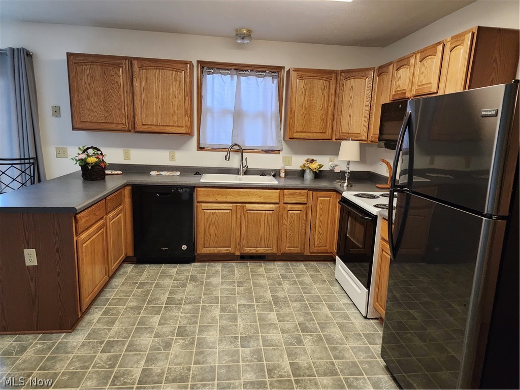 176 Overhill Road Youngstown, OH 44512 - Photo 6 of 20 Kitchen featuring sink, stove, refrigerator, light tile floors, and dishwasher
