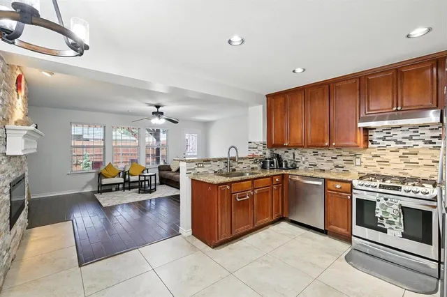 a kitchen with stainless steel appliances granite countertop a stove and cabinets