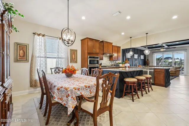 a kitchen with a table chairs and cabinets