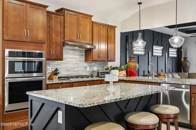 a kitchen with a table chairs stove and refrigerator