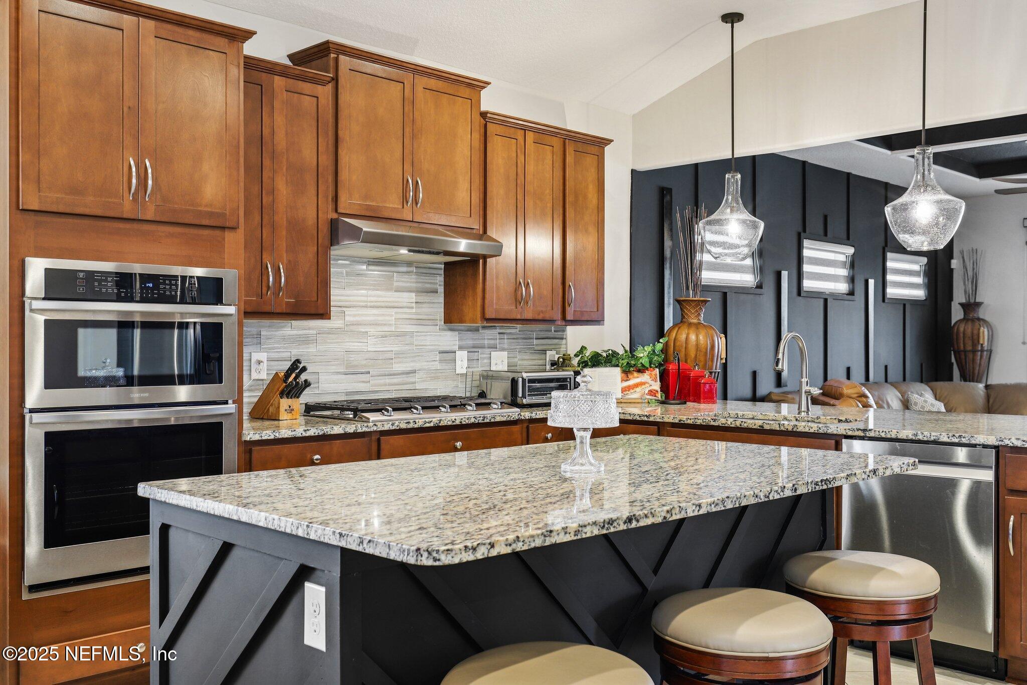 48 Fawn Field Lane St. Augustine, FL 32092 - Photo 14 of 73 a kitchen with a table chairs and cabinets