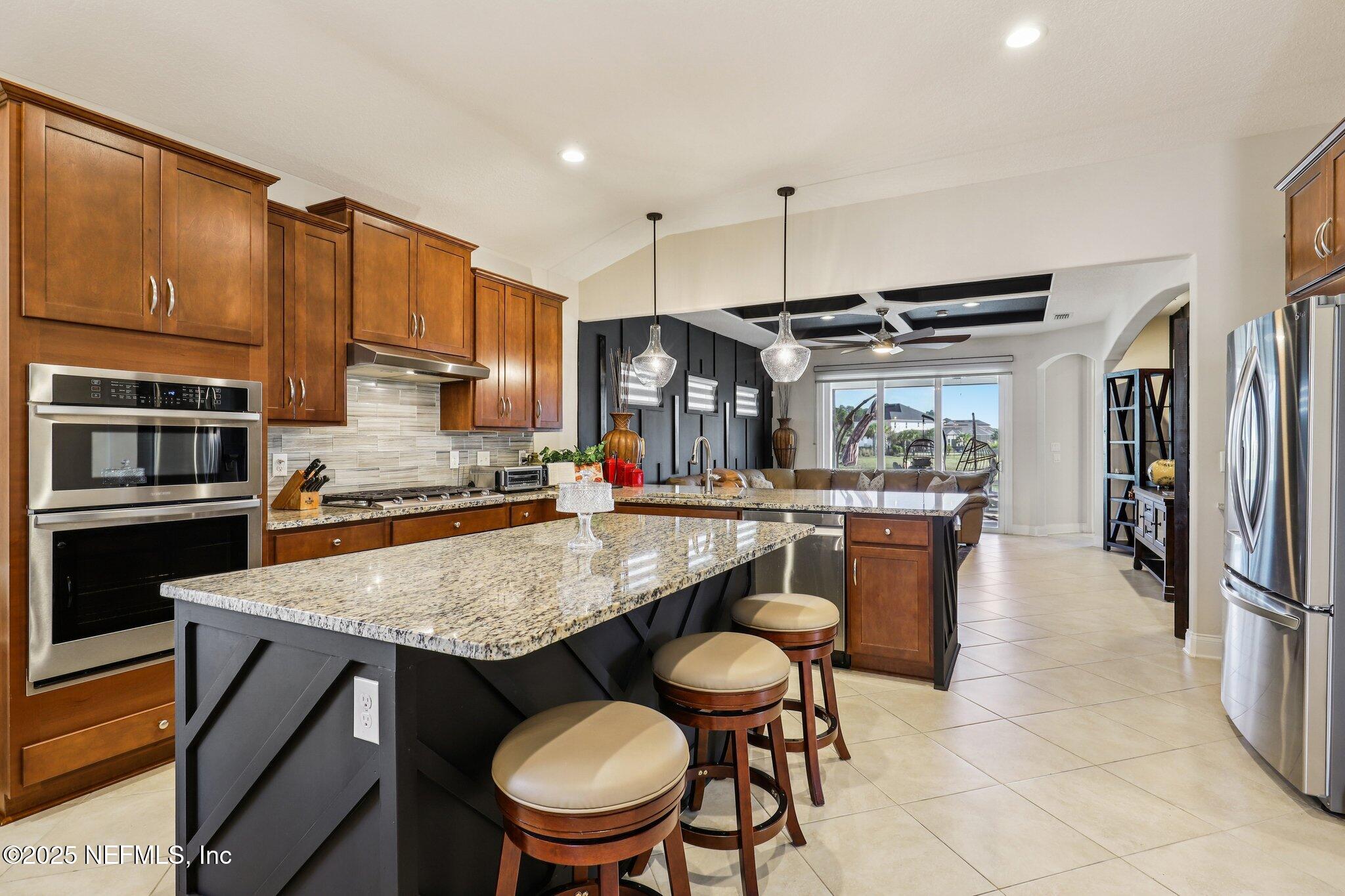 48 Fawn Field Lane St. Augustine, FL 32092 - Photo 16 of 73 a kitchen with a table chairs stove and refrigerator