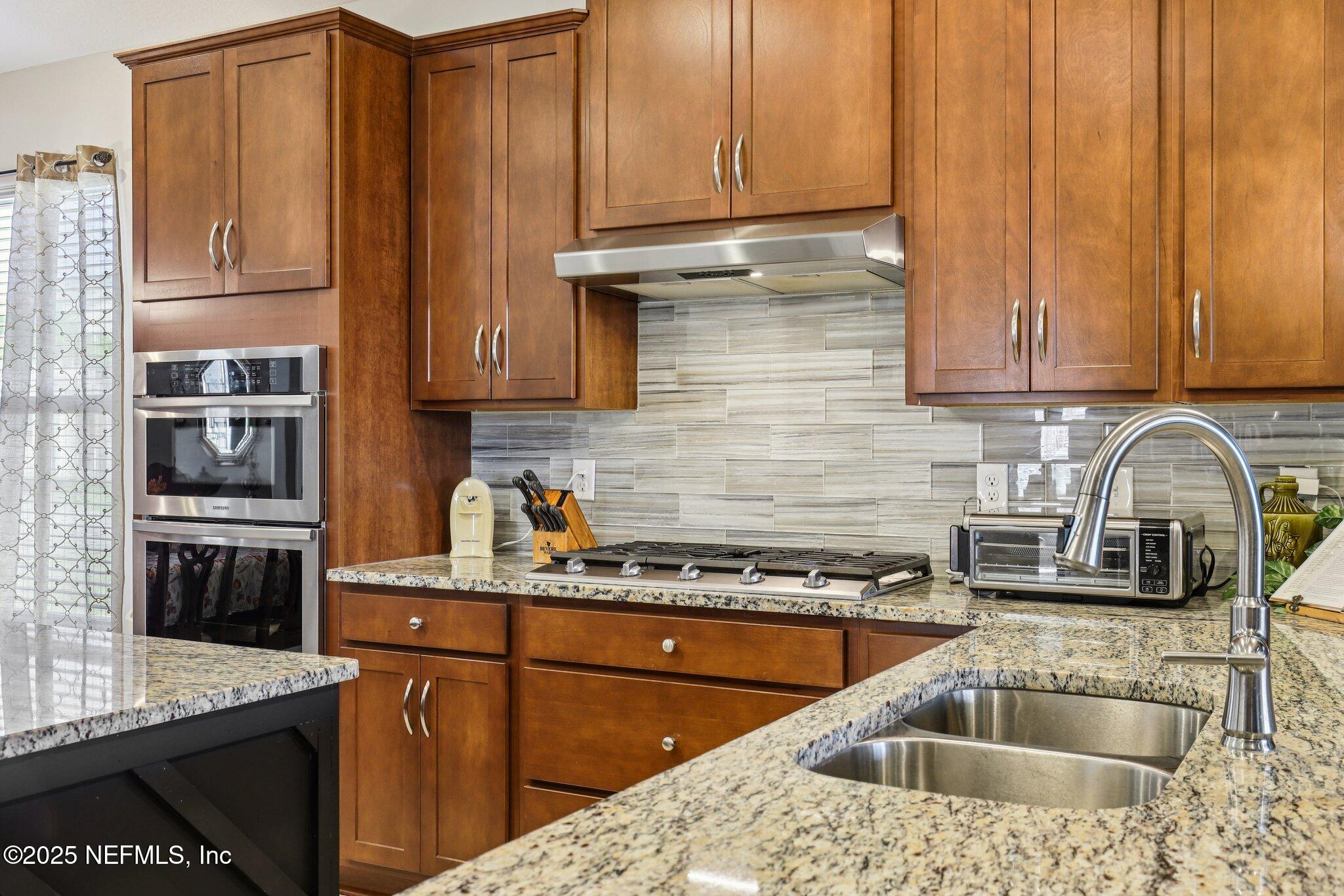 48 Fawn Field Lane St. Augustine, FL 32092 - Photo 20 of 73 a kitchen with stainless steel appliances granite countertop a sink stove and refrigerator