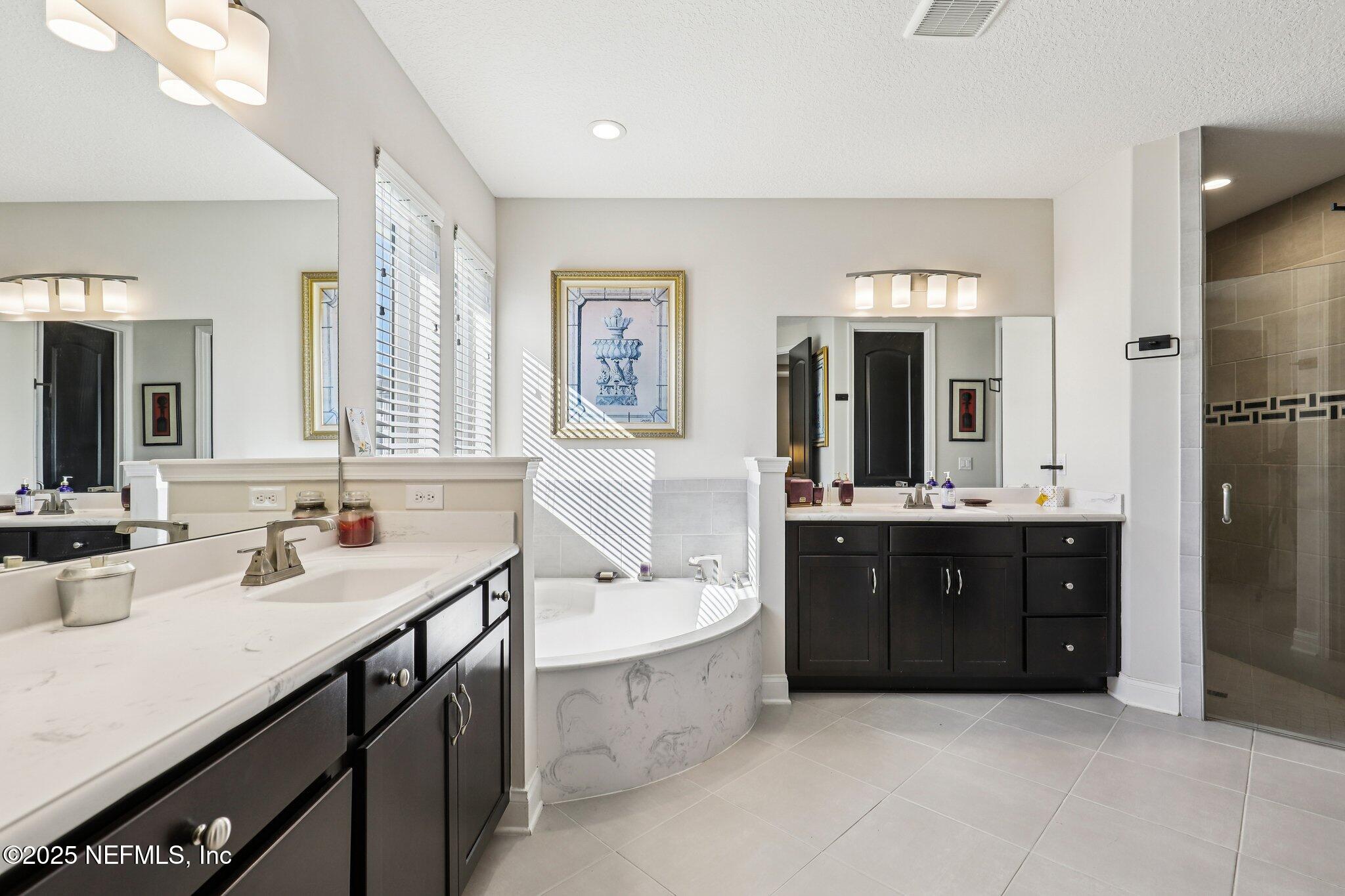 48 Fawn Field Lane St. Augustine, FL 32092 - Photo 26 of 73 a spacious bathroom with a double vanity sink mirror and bathtub