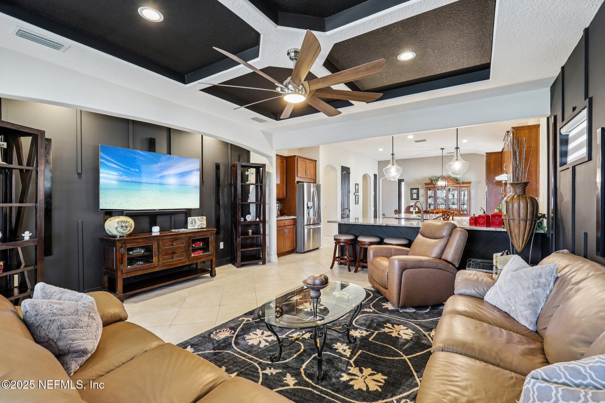 48 Fawn Field Lane St. Augustine, FL 32092 - Photo 6 of 73 a living room with furniture ceiling fan and a flat screen tv
