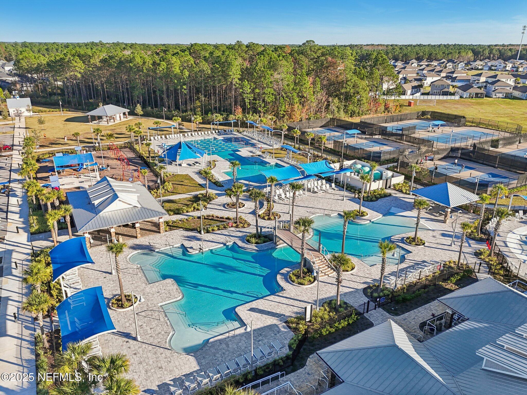 48 Fawn Field Lane St. Augustine, FL 32092 - Photo 62 of 73 a view of swimming pool with outdoor seating and a floor to ceiling window