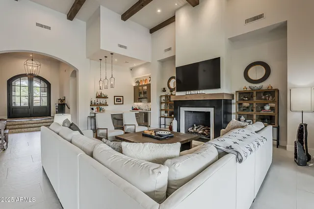 a kitchen with a stove cabinets and chairs