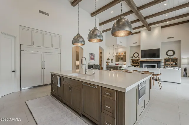 a spacious bedroom with a bed and a flat screen tv