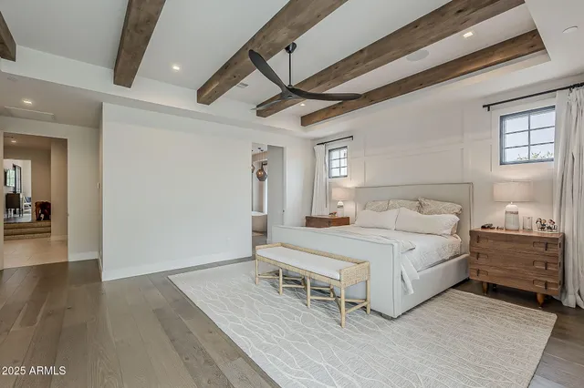 a bedroom with a bed and a painting on the wall