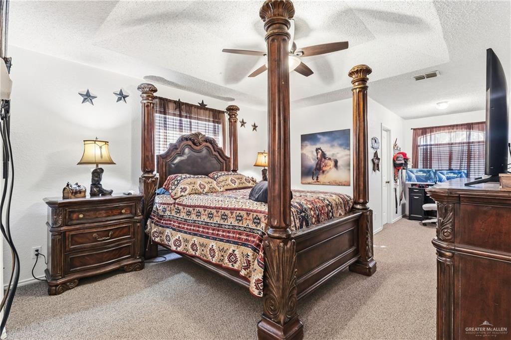 301 Cardinal Avenue McAllen, TX 78504 - Photo 14 of 17 a bed room with a bed and a chandelier