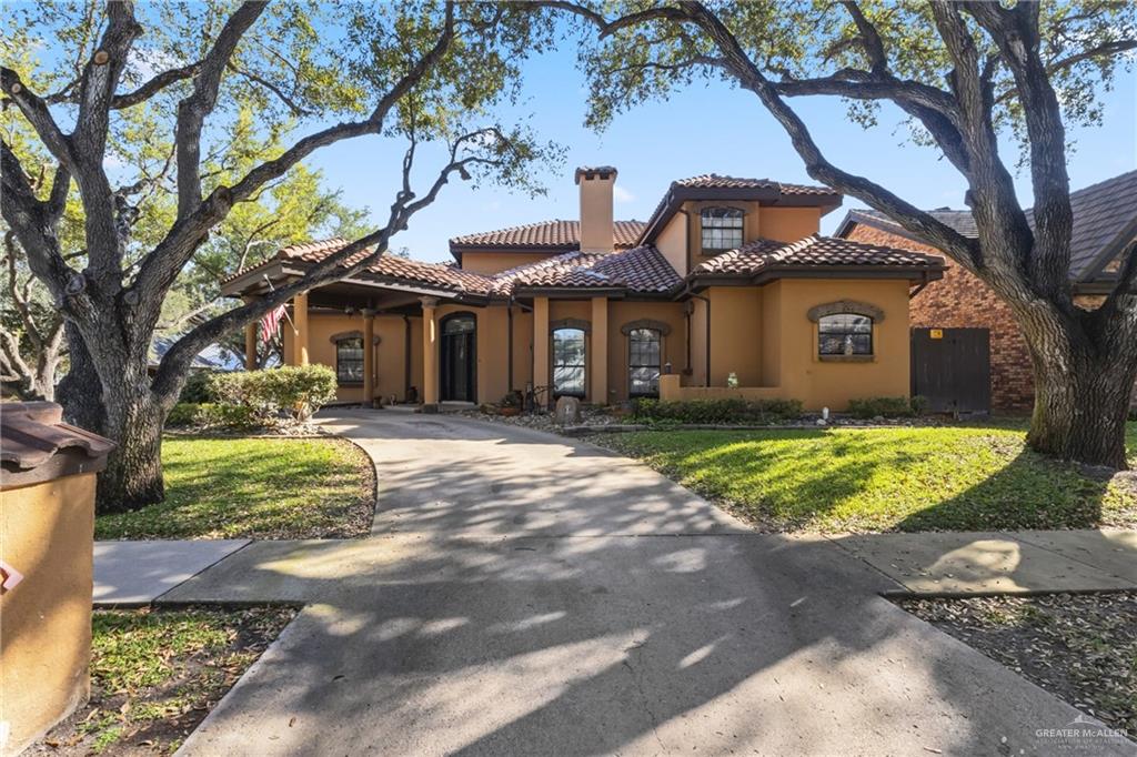301 Cardinal Avenue McAllen, TX 78504 - Photo 2 of 17 a front view of a house with garden