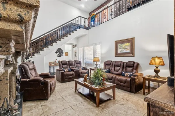a living room with furniture ceiling fan and a rug