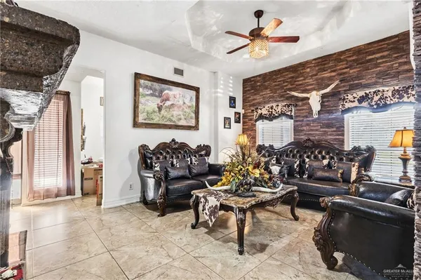 a living room with furniture and a dining table