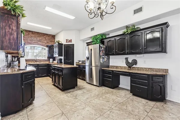 a kitchen with a stove a sink and a refrigerator