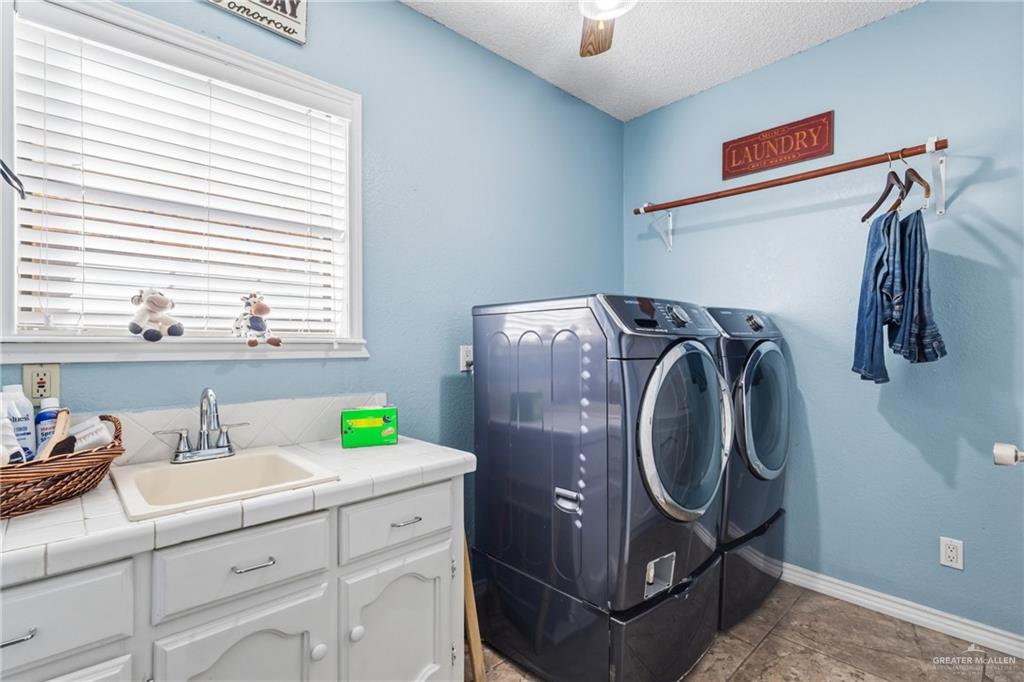301 Cardinal Avenue McAllen, TX 78504 - Photo 10 of 17 a utility room with cabinets washer and dryer