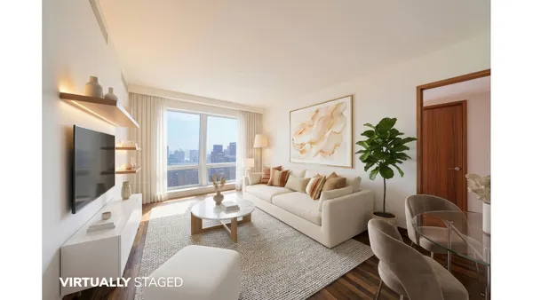 a living room with furniture a flat screen tv and a large window