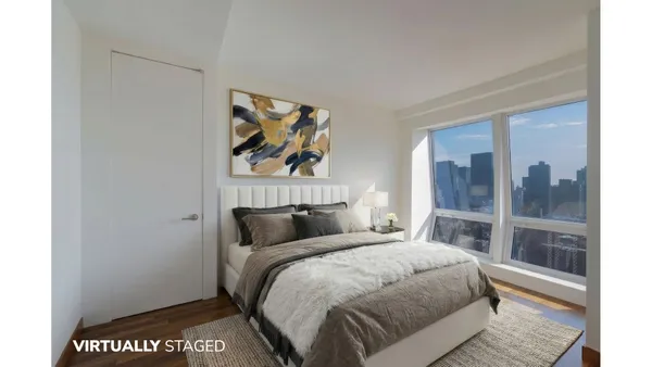 a bedroom with a bed and glass door