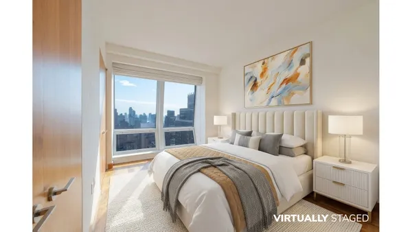 a bedroom with a bed and a large window