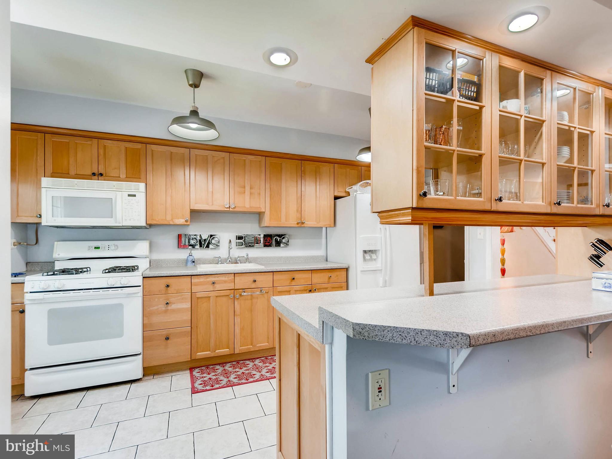 202 Blenheim Road Baltimore, MD 21212 - Photo 13 of 30 Galley kitchen with tile floor, place for stools