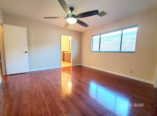 419 South Lorie Ann Street Ridgecrest, CA 93555 - Photo 12 of 27 a view of an empty room with wooden floor and a window