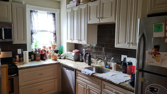 a view of a dining room with furniture and window