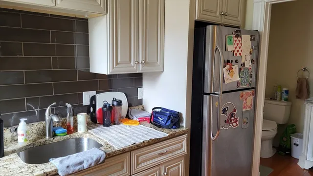 a kitchen with granite countertop stainless steel appliances and a sink