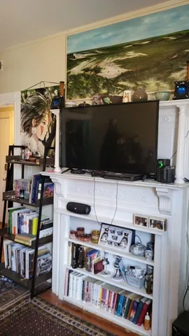 a room with furniture and painting on the wall