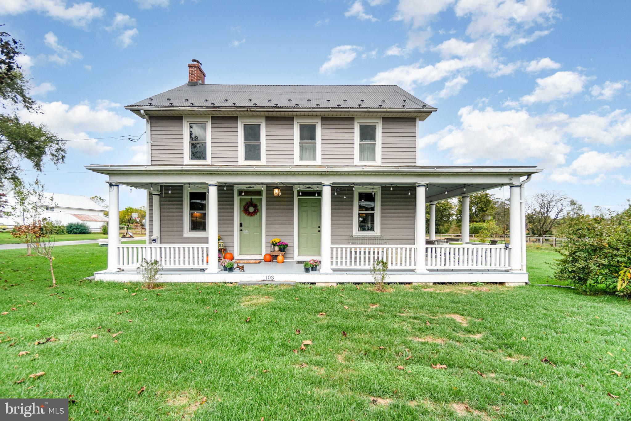 a front view of a house with a yard and porch